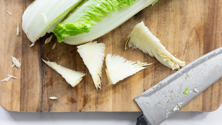 cabbage cores on chopping board with knife