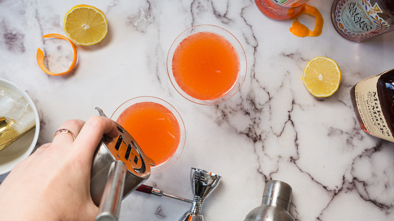 Pouring cocktail into glasses