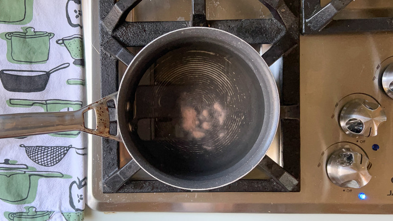 Water and salt in pot on stove