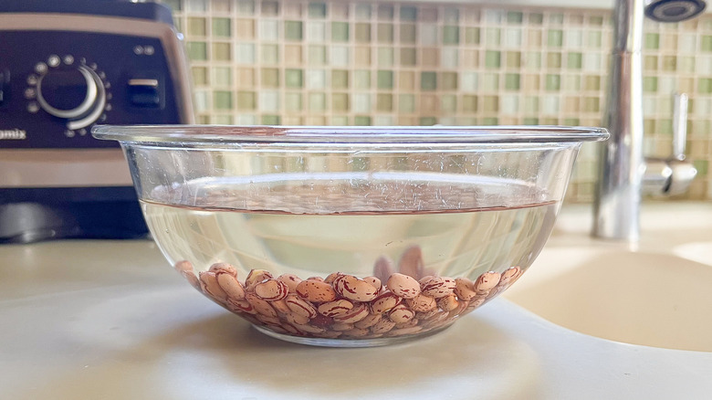 Cranberry beans soaking in water in bowl