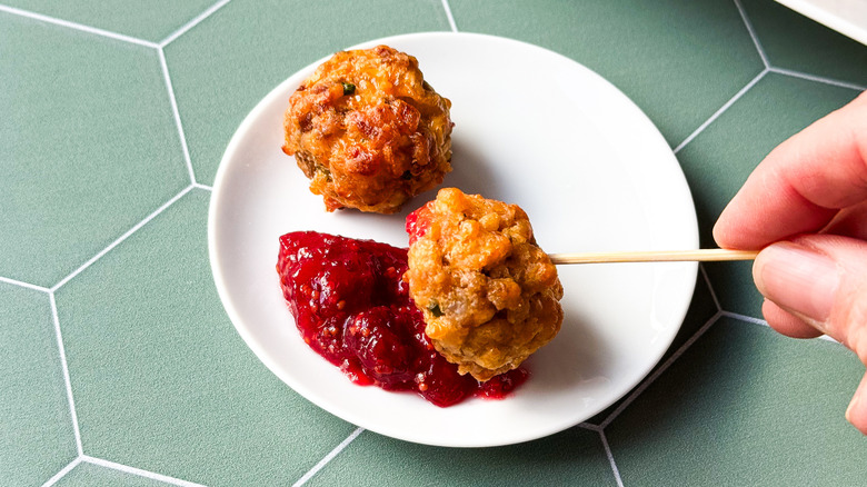 Classic sausage balls on plate and toothpick with cranberry mustard dipping sauce