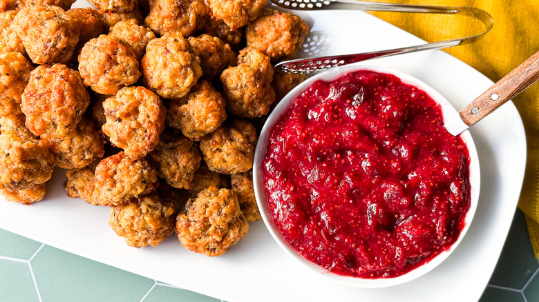 Classic sausage balls with cranberry mustard on serving platter