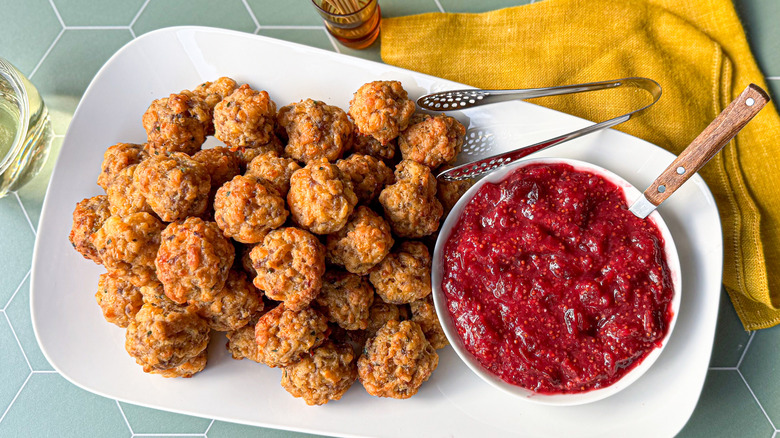 Classic sausage balls on serving platter with cranberry mustard dipping sauce