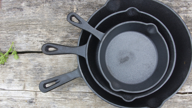 three stacked cast iron pans