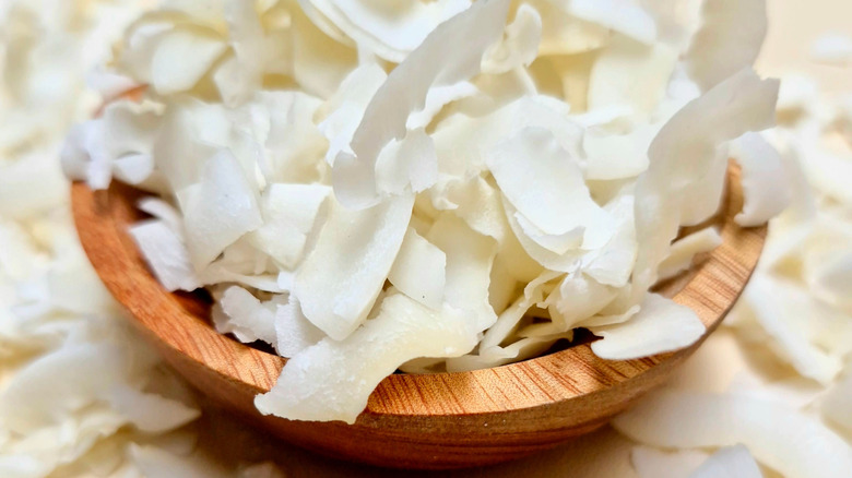 Wooden bowl full of coconut flakes