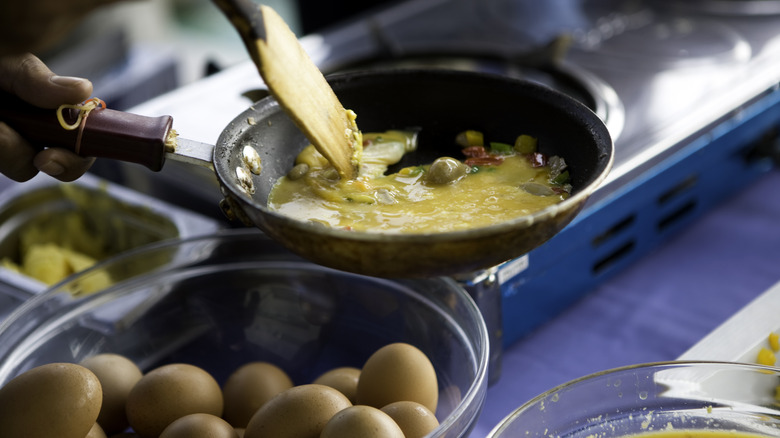cooking scrambled eggs in pan