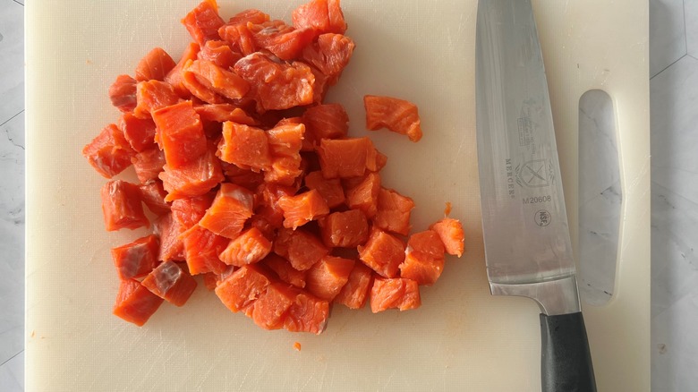 chopped salmon chunks with knife