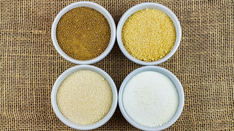 Various sugars in white bowls