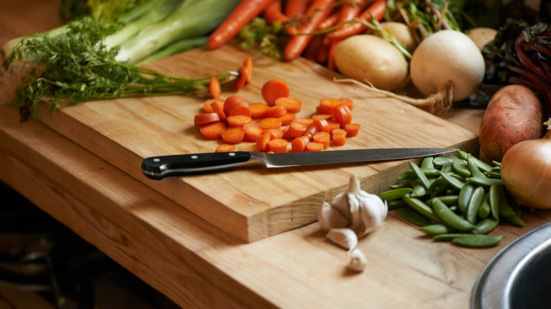 Vegetables and knife on board
