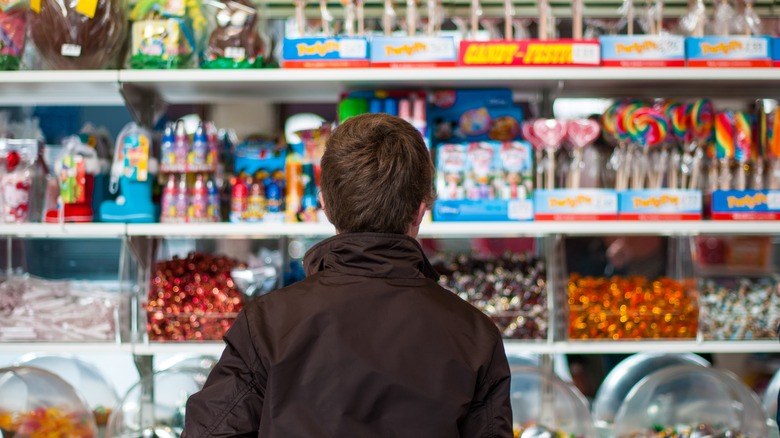 Child choosing candy at store