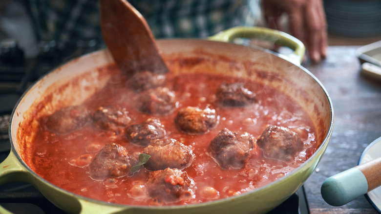 Meatballs simmering in tomato sauce