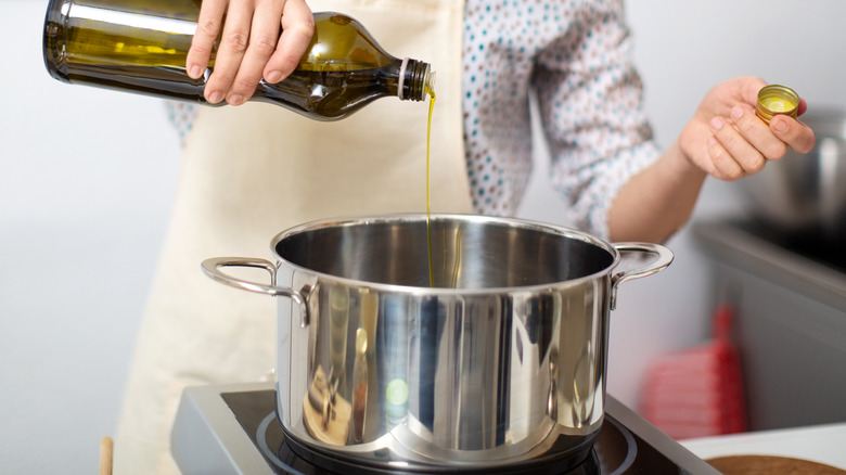 Adding oil to a pot