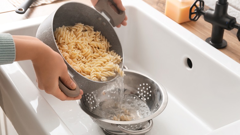 Draining pasta in the sink