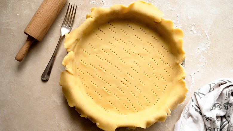 Raw pie crust in a pan