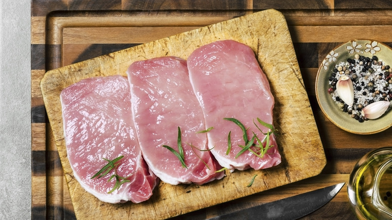 Pork chops on cutting board