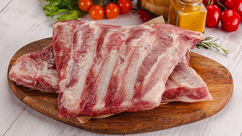 Raw pork ribs on board