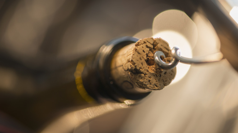 opening wine with a corkscrew