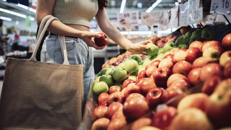 Person shopping for apples