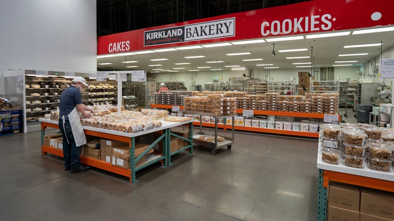 Costco employee organizing bakery section