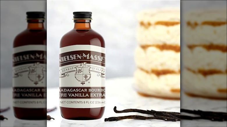 Vanilla extract bottle with cake and vanilla bean