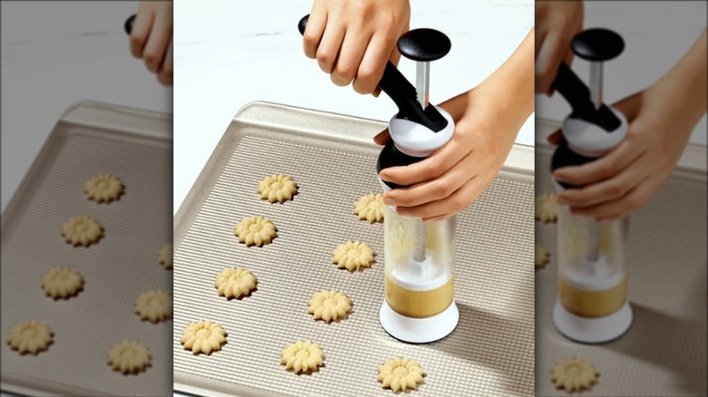 Cookie press with flower-shaped cookies