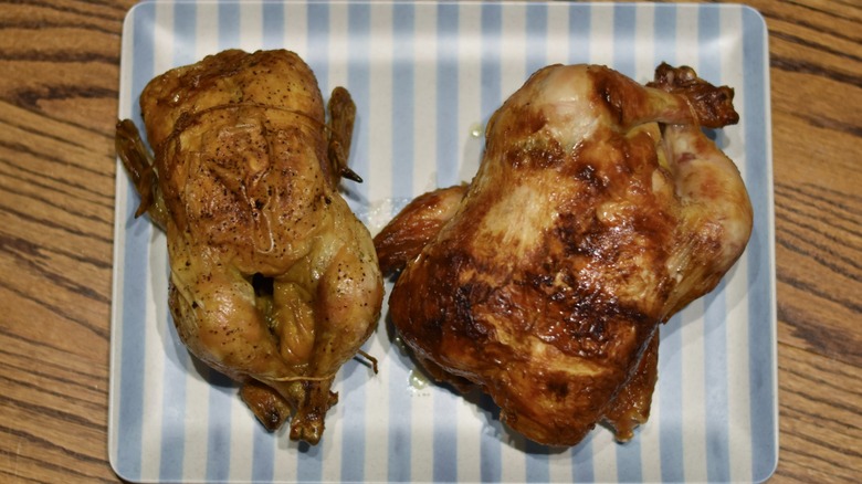 A Kirkland Signature rotisserie chicken on the right next to a Whole Foods rotisserie chicken on the left