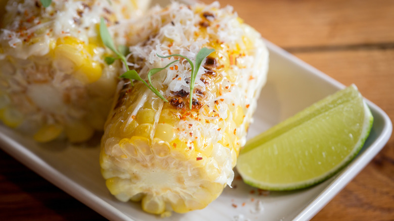 Corn cob with cotija cheese and lime