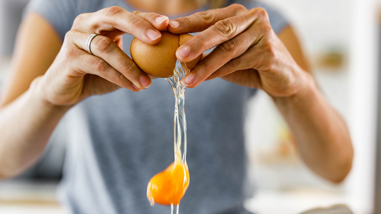 Person cracking egg