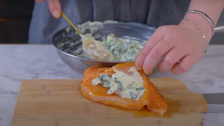 Person cutting a pocket into a chicken breast