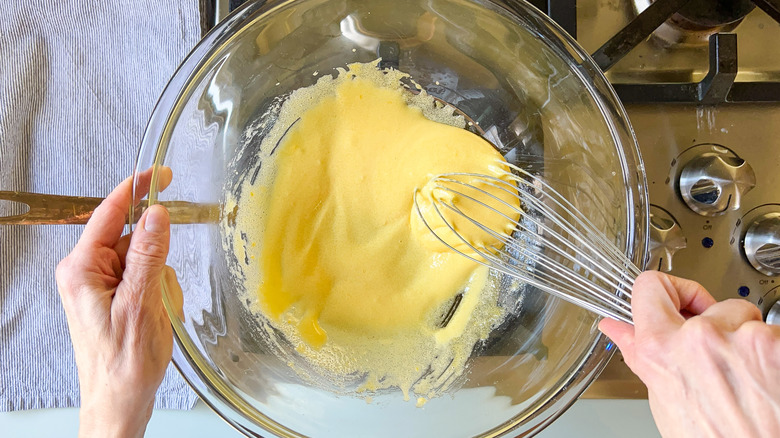 whisking yolks and sugar over water bath