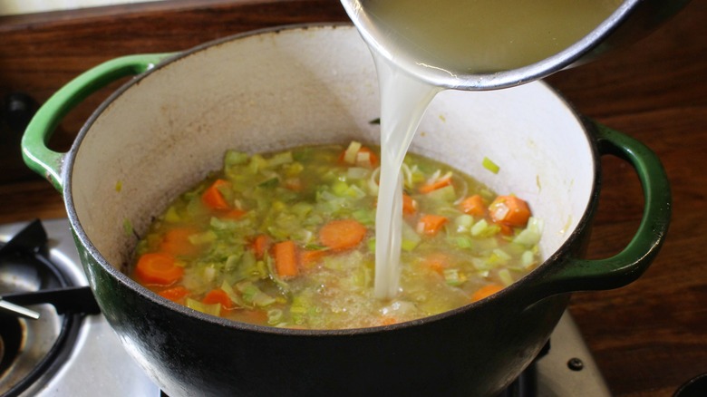 pouring broth into pot