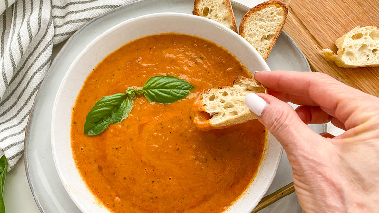 dipping bread into soup