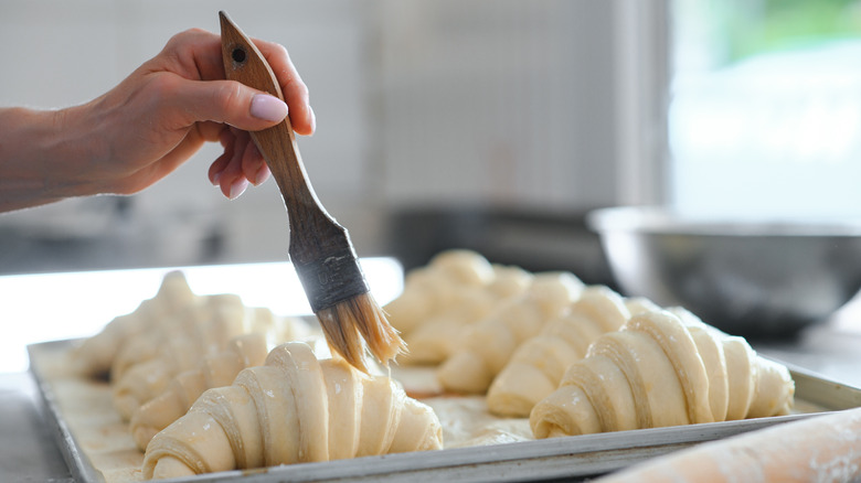 Pastry brush on croissants