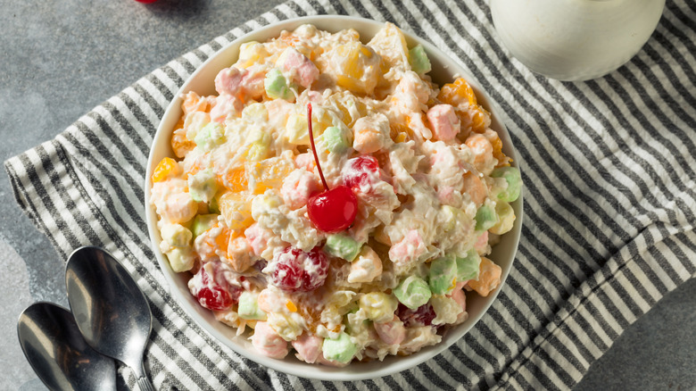 Ambrosia salad topped with cherries.