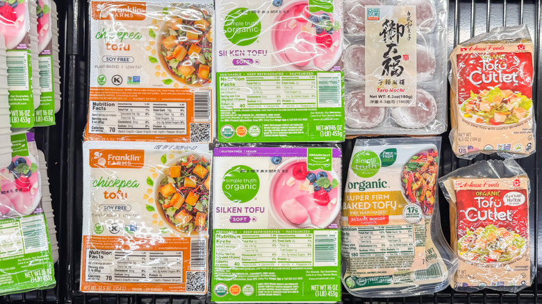 Various packages of tofu in grocery case