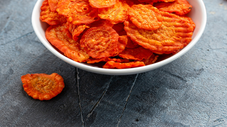 Baked carrot chips in a white bowl