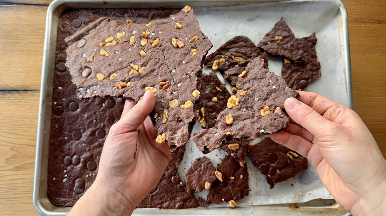 Shards of brownie brittle broken up by hands