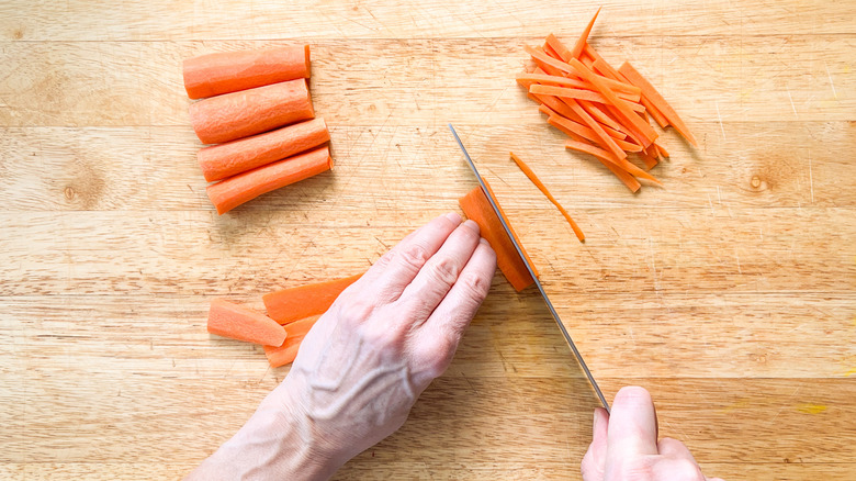 carrots being cut on board