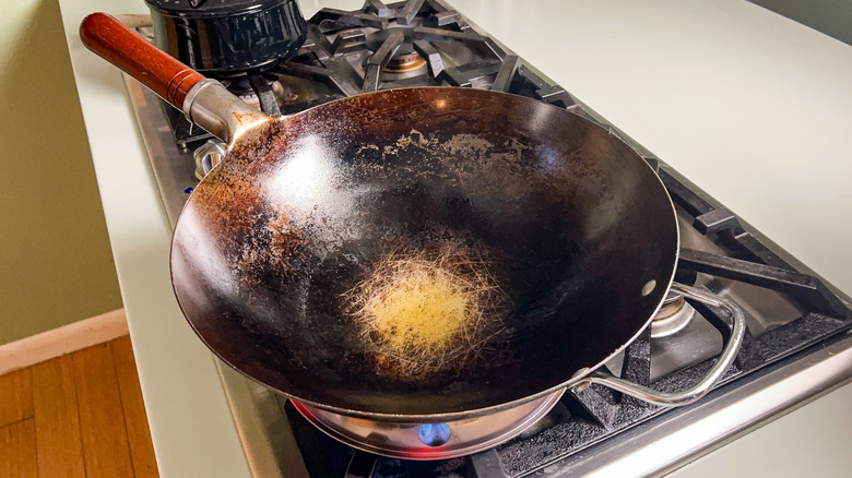 Heating avocado oil in wok on stove top