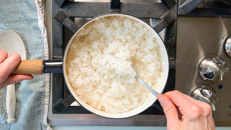 fork fluffing rice in pot