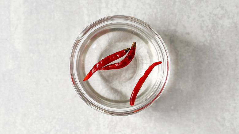 Soaking dried Thai chiles in water