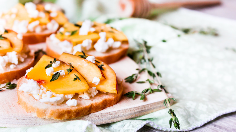 Crostinis topped with feta and sliced peaches