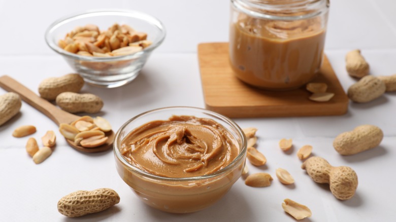 Peanut butter and peanuts on a table