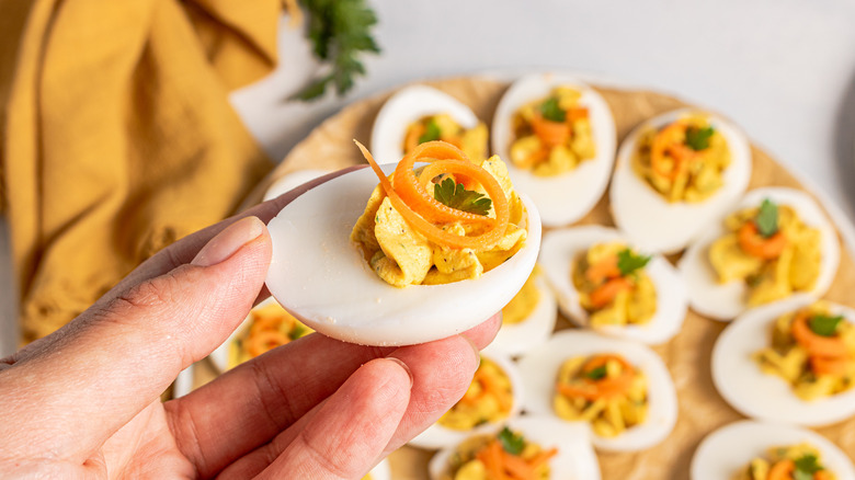 Holding a deviled egg