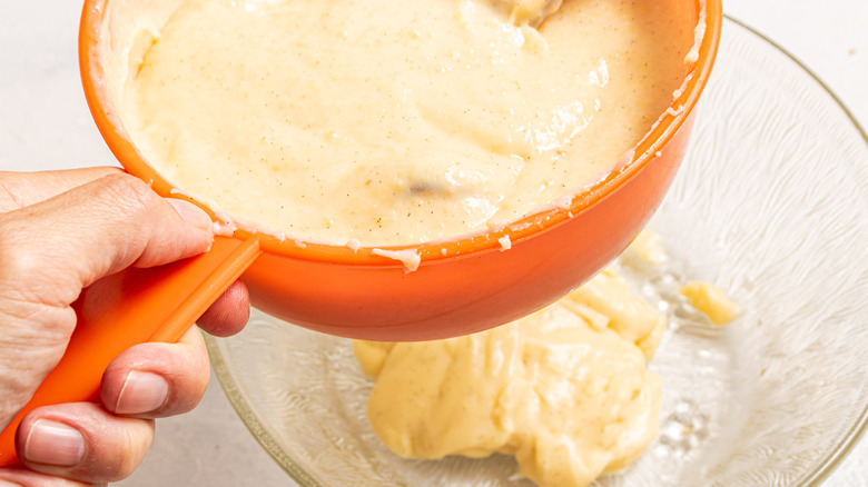 Passing pastry cream through a sieve