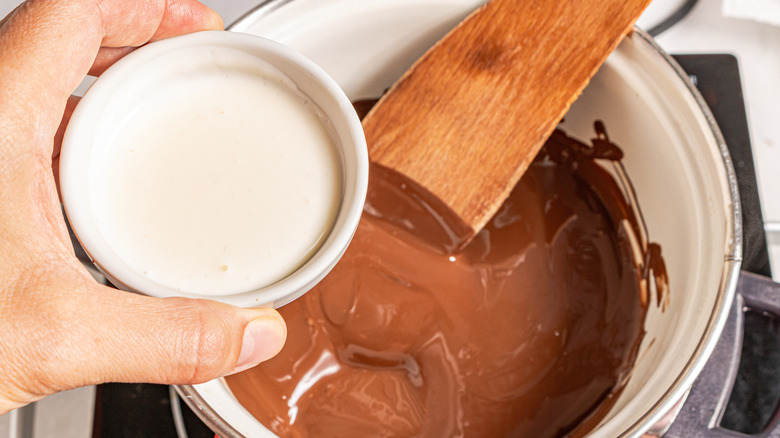 Adding milk to melted chocolate