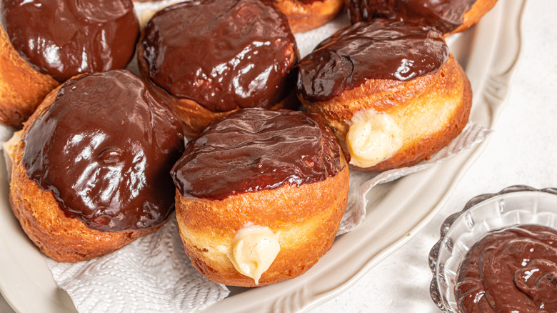 Custard-filled Boston cream donuts on a plate