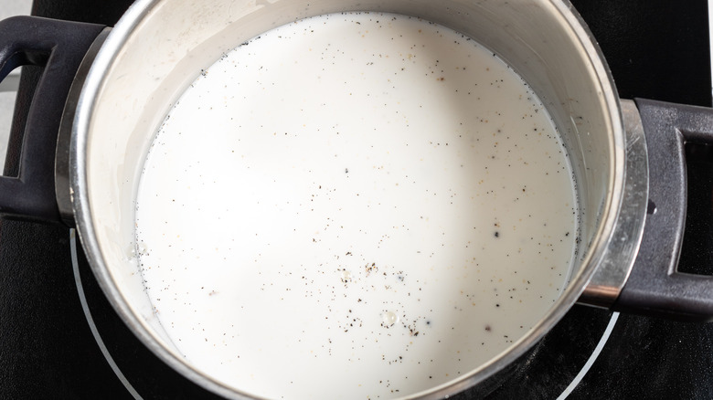 Milk with vanilla seeds in a saucepan