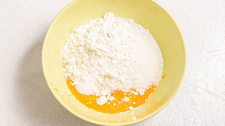 Bowl with egg yolks, sugar, salt, and cornstarch