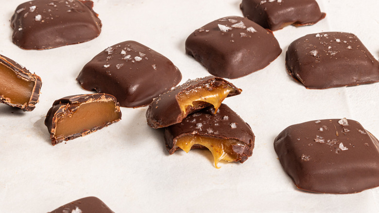 Chocolate-covered caramels cut and whole